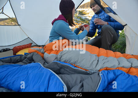 Mann, die Übergabe von Kaffee an Freundin im Zelt am See Schuld, Selkirk Mountains, Idaho Stockfoto