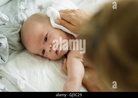 Mütter die hand waschen Baby Söhne Gesicht Stockfoto