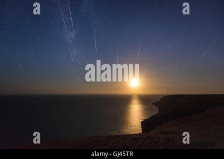 Pembrokeshire, Wales, UK. 12. August 2016. Der Einstellung Mond spiegelt sich im Meer an der Küste von Pembrokeshire in Wales, im Bild ist eine Zusammenstellung von einer Stunde im Wert von Meteoren aus den Perseiden Meteorschauer Stockfoto