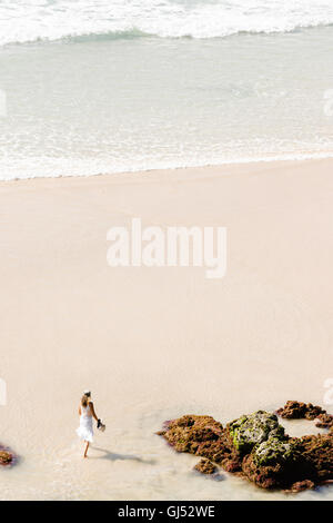 Eine Frau Wategos Strand in Byron Bay entlang spazieren. Stockfoto