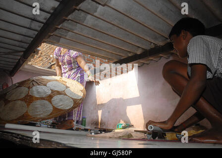 Alle Mitglied der Familie machen Papads an ihre Heimat im Slum Dharavi, Mumbai in Indien am 26. Octobar 2013 Stockfoto