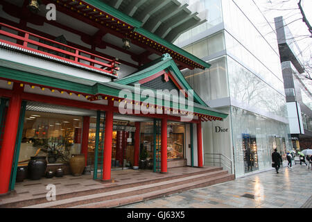 Entlang der Omotesando Avenue sind die roten "Oriental Bazaar", das traditionelle japanische Souvenirs neben dem Milchglas Dior verkauft Stockfoto