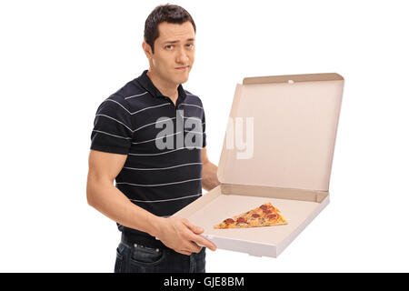 Enttäuscht junger Mann hält eine Pizza-Box mit einem Stück Pizza in ihr isoliert auf weißem Hintergrund Stockfoto