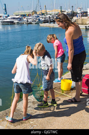 Poole, Dorset, UK. 16. August 2016. UK-Wetter: Kinder und Erwachsene gehen an einem heißen sonnigen Tag mit ununterbrochenen Sonnenschein Credit bei Poole Quay Verdrehungen: Carolyn Jenkins/Alamy Live News Stockfoto