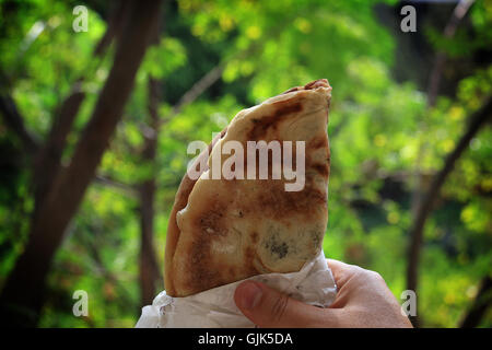 Ein Mann hält ein Mankousheh, traditionelle libanesische Frühstück. Stockfoto