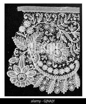 Echte Duchesse-Spitze hat eine reiche Geschichte, die aus Europa stammt, wo sie akribisch von Hand gefertigt wurde und einen hohen Standard an Handwerkskunst darstellt. Bekannt für ihre zarten und komplizierten Muster, ist die Spitze der Duchesse ein traditionelles Textil, das seit Jahrhunderten wegen seiner Schönheit und geschickten Herstellung geschätzt wird. Stockfoto