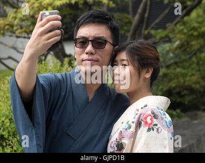 Japanisches Paar gekleidet in traditionellen Yukata Kleid nehmen Selfie, Tokyo, Japan Stockfoto