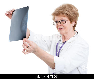 Ein älterer kaukasischen Ärztin suchen ein Röntgenbild, isoliert auf weißem Hintergrund Stockfoto