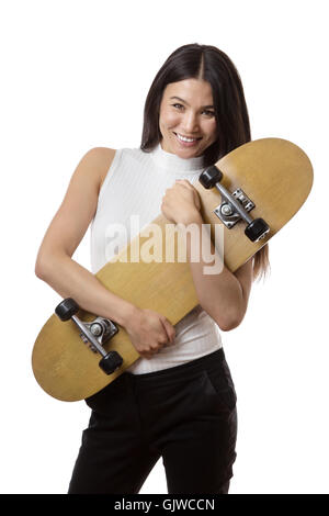 Geschäftsfrau hält eine Skateboard gedreht im studio Stockfoto