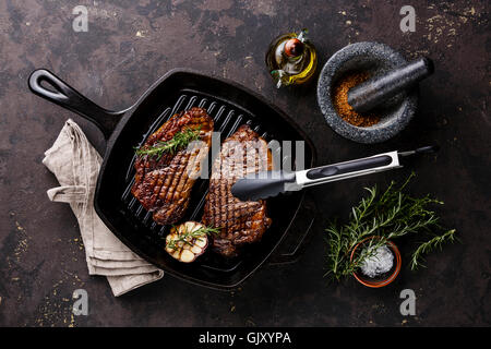 Gegrillte Black Angus Steak Striploin auf Gusseisen Grill Bratpfanne auf dunklem Hintergrund Stockfoto
