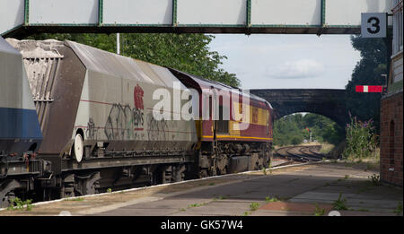 DB Cargo Klasse 66 Diesellok arbeiten einen Zug der leeren Behälter Wagen (verwendet für den Transport von Sand) Haltestelle Helsby, Cheshire Stockfoto