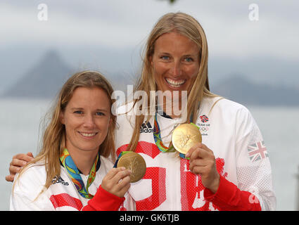 Great Britain Hannah Mills und Saskia Clark (rechts) auf dem Podium mit ihren Goldmedaillen von 470 Frauenlauf in der Marina da Gloria am dreizehnten Tag der Olympischen Spiele in Rio, Brasilien zu feiern. Stockfoto