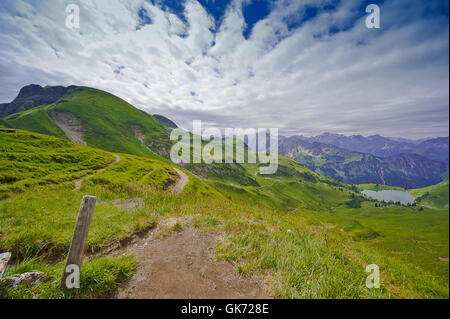 grüne Wiesen mit Seealpsee im Sommer Stockfoto