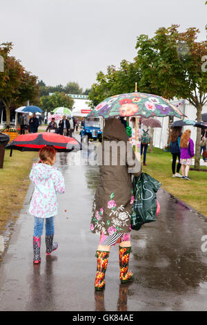 Flower Show in Southport, Merseyside, UK. 19 Aug 2016: Schwere Regenfälle könnte nicht die Geister der Besucher dämpfend auf die diesjährige Southport Flower Show. Sonnenschirme und wellies, & Gummi Stiefel waren die Top Fashion Tipp des Tages. Der größte unabhängige flower show in England, erwartet Tausende Besucher im Laufe der viertägigen Veranstaltung. Credit: MediaWorld Images/Alamy leben Nachrichten Stockfoto