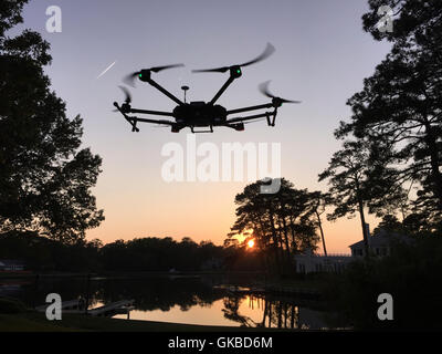 DJI Matrice 600 fliegen über einem See in der Abenddämmerung in Virginia Beach, VA Stockfoto