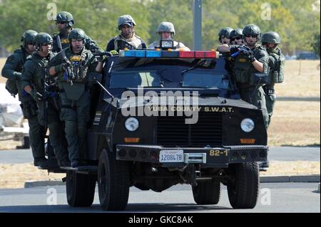 Yuba County Sheriff Department SWAT-Mitglieder ihre Waffen ziehen und bewerten die Szene einer aktiven Shooter-Übung im military-Stil Training auf der Beale Air Force Base 17. August 2016 in Yuba, Kalifornien. Stockfoto