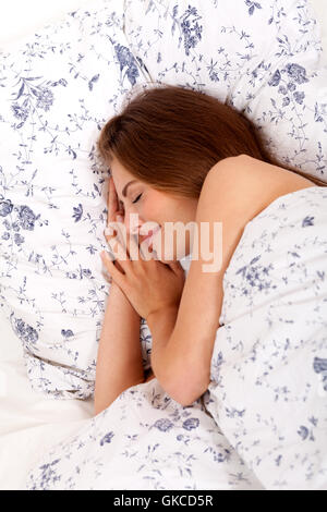 junge attraktive Frau morgens schlafend im Bett liegend Stockfoto