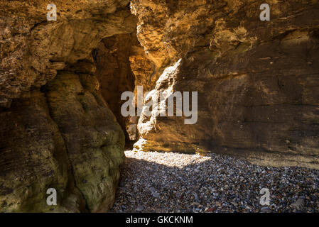 Höhlen von Klippen von Gelben magnesiumhaltigen Kalkstein in Seaham Strand, County Durham, UK erodiert Stockfoto