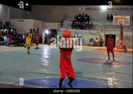 Am 13. März 2015 versuchte ein Spieler des Basketballteams Heegan einen Schuss während eines Spiels gegen Horseed im Distrikt Abdiaziz, Mogadischu. Basketball ist in Somalia weit verbreitet, viele genießen Spiele in der Stadt, da relativer Frieden herrscht. AMISOM Photo / Ilyas Ahmed Stockfoto