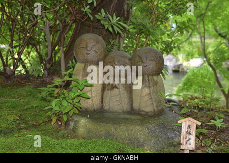 Niedliche kleine Statuen beten in einem Zengarten in Japan Stockfoto