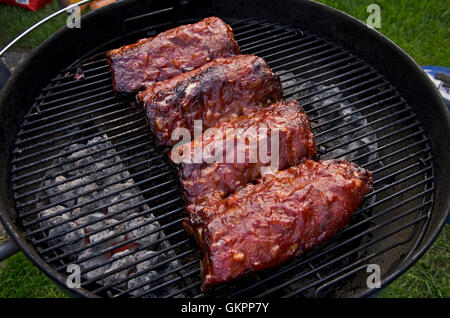 Schweinefleisch Baby back ribs auf einem Holzkohlegrill Stockfoto