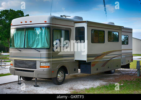 Vorder- und Seitenansicht Ansicht von 32ft Klasse A Wohnmobil mit Slideouts in einem Park in Florida Stockfoto