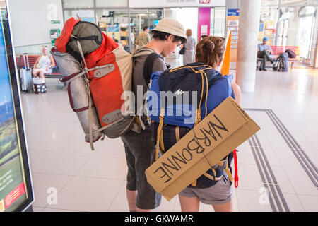 Per Anhalter Coupleat Perpignan Bahnhof, Perpignan.Hoping, die Stadt zu verlassen. Trampen Sie, Südfrankreich. Stockfoto