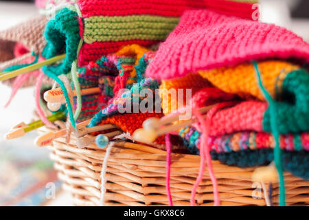 Knitting needles and colorful wool in a wicker basket Stockfoto