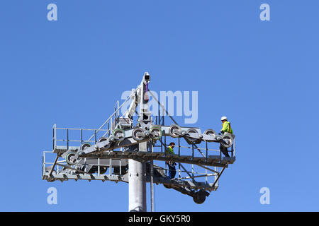 El Alto, Bolivien, 23. August 2016. Techniker warten an einem Hochspannungsmast, ein synthetisches Lichtkabel für eine neue Seilbahn zu installieren / Gondelbahn, die derzeit im Bau zwischen dem Rio Seco und La Ceja in El Alto. Dies ist der erste Teil des Prozesses, das endgültige Stahlseil zu installieren, das Gondeln tragen wird. Diese Seilbahn gehört zu einer zweiten Phase der Seilbahn-Linien, die Teil eines ehrgeizigen Projekts um Verkehrsstaus zu lindern sind. 3 Routen aus der ersten Phase sind bereits zwischen den Städten La Paz und El Alto in Betrieb. Bildnachweis: James Brunker / Alamy Live News Stockfoto