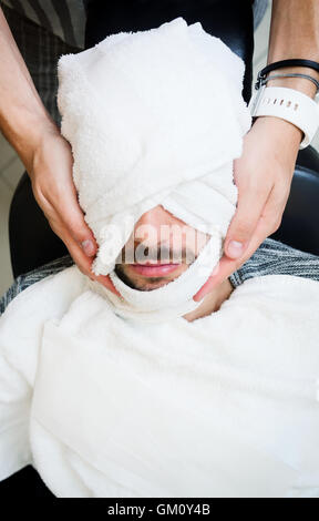 Traditionelles Ritual der Rasur des Bartes mit warmen und kalten Kompressen in einem alten Stil-Friseur. Stockfoto