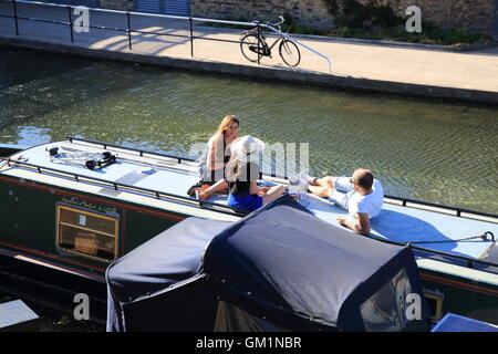 Gruppe von Freunden entspannen auf dem Dach von einem Lastkahn am Regents Kanal, am trendigen Kings Cross, Nord-London. Stockfoto