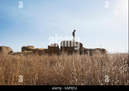 Junge (6-7) Stand am Ballen Heu Stockfoto