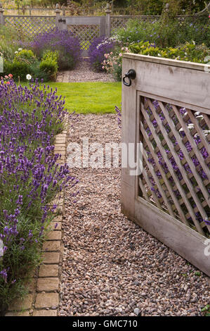 Lavendel und offene Tor, führt in eine schöne, traditionelle, entworfen, gepflegten, privaten Garten - North Yorkshire, England. Stockfoto