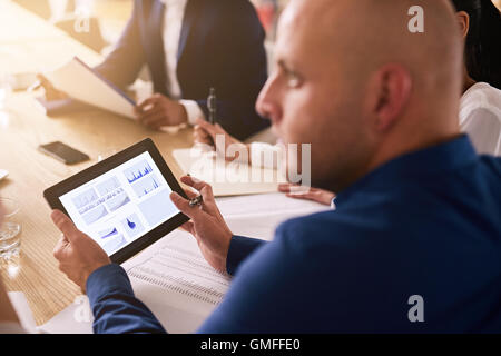 Tablet in einen Geschäftstermin mit Grafiken auf dem Bildschirm Stockfoto