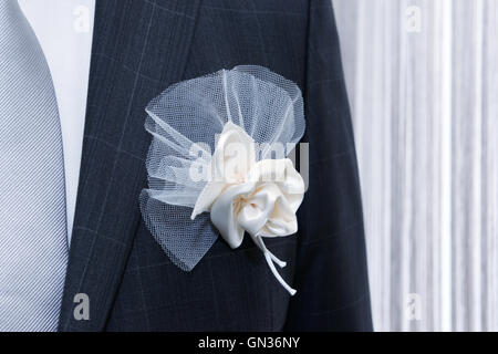 Bräutigam Hochzeit Anzug mit floralen Tasche Dekoration auf Vorderseite des leichten Vorhang am Fenster Stockfoto