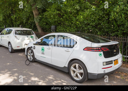 New York City Parks Abteilung Chevy Volt und Nissan Leaf Elektroautos bekommen eine Ladung an einer Ladestation im Central Park. Stockfoto