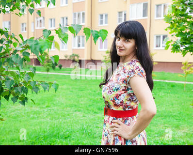 Porträt von eine schöne junge Brünette in einem park Stockfoto