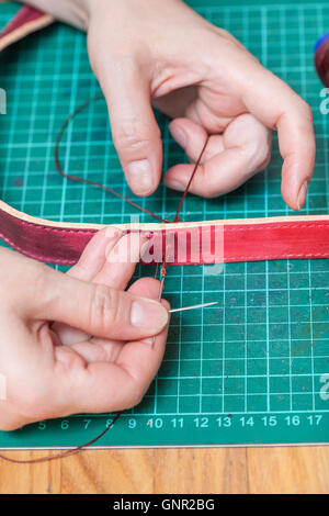 Lederverarbeitung - Handwerker näht neue Ledergürtel Stockfoto