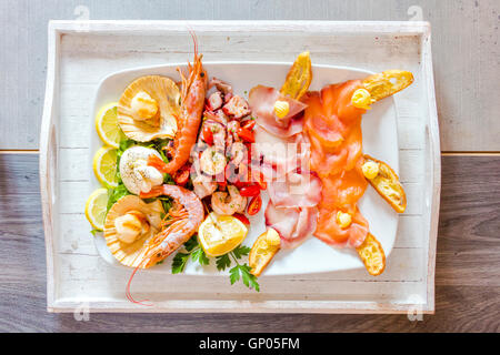 Frische Krebse mit Lachs und Garnelen serviert mit Gemüse ein gesundes Gericht typisch für italienische Küche Stockfoto