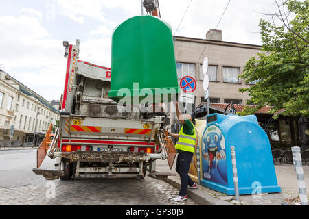 Sofia, Bulgarien - 26. Mai 2016: Ein sanitärer Arbeiter ist Edelstahl Mülleimer mit seinem recycling LKW Abholung. Behälter für separat sammeln Stockfoto