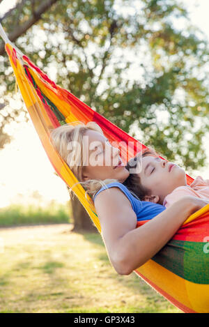 Mutter und Sohn zusammen ein Nickerchen in der Hängematte Stockfoto