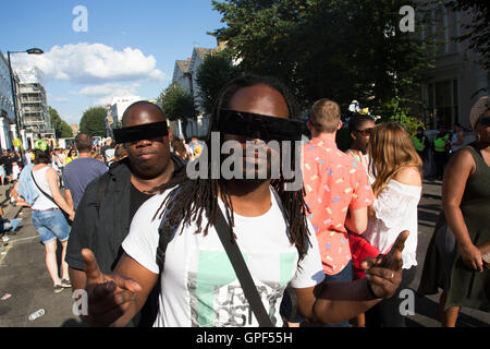 Abendlicht an der Westbourne Park Road auf Sonntag, 28. August 2016 bei den 50. Notting Hill Carnival in Westlondon. Ein Fest der Westindischen / Karibik Kultur und Europas größte Straßenparty, Festival und Parade. Nachtschwärmer kommen in hunderttausenden zum Spaß haben, tanzen, trinken und loslassen in die tolle Atmosphäre. Es wird geführt von den Mitgliedern der West-indischen / Karibische Gemeinschaft, besonders die Trinidad und Tobagonian britische Bevölkerung, von denen viele seit den 1950er Jahren in der Gegend gelebt haben. Der Karneval hat in der Vergangenheit und eine Parade im Zentrum bis zu 2 Millionen Menschen angezogen. Stockfoto