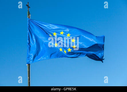 Flagge von Europa, oder europäischen Fahnenschwingen auf eine Fahnenstange über klar blauer Himmelshintergrund Stockfoto