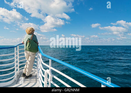 Florida Keys, Key Largo, John Pennekamp Coral Reef State Park, weibliche Besucher am Bug des Glasbodenboot aufbrechen, um Riff Stockfoto