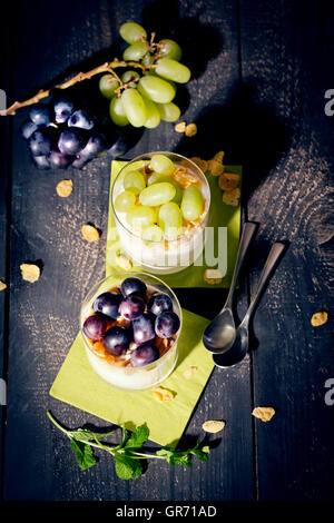 Magerer Joghurt mit Cornflakes und Trauben frischer Minze Stockfoto