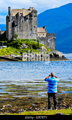 Mann die Fotos von Eilean Donan Castle, Dornie, westliche Ross-Shire, Schottland, Vereinigtes Königreich Stockfoto
