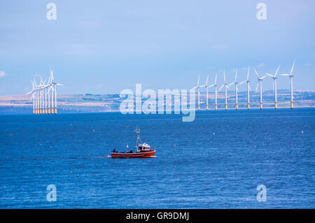 Ein Fischerboot von Teesside Windpark gesehen von der Landzunge, Hartlepool, County Durham, England Stockfoto