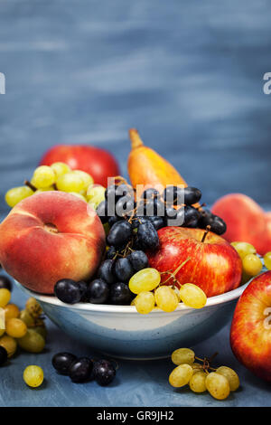 Frische reife herbstliche Früchte - Pfirsiche, Birnen, Äpfel und Trauben Stockfoto