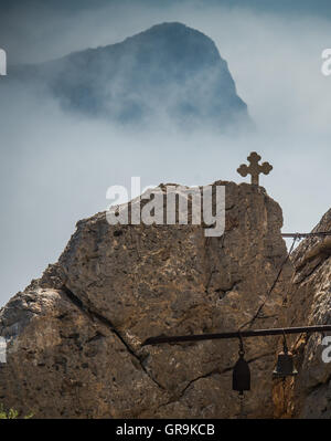 Kreuz und Glocken eine orthodoxe Kapelle In den Bergen von Kreta Griechenland Stockfoto