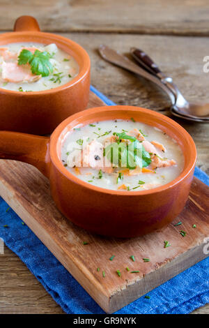 Lachssuppe mit Nudeln und Gemüse in Keramikschalen hautnah Stockfoto